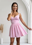  stylish pink gingham midi dress with corset detailing, offering a flattering fit and modern elegance for any occasion.