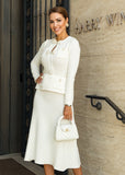 Chic white midi dress at ShopPegasi featuring a flattering peplum design and belted waist, ideal for modern day-to-night looks.