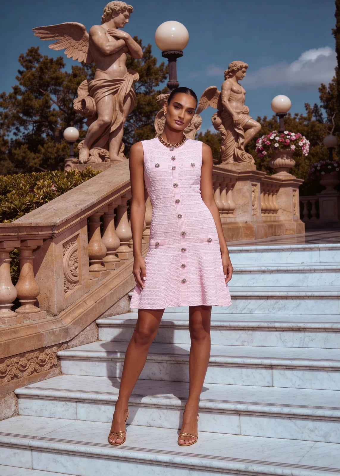 Feminine blush knit mini dress crafted from soft knit fabric with a flattering flared silhouette.
