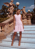Feminine blush knit mini dress crafted from soft knit fabric with a flattering flared silhouette.