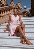 Women's blush pink knit mini dress showcasing a flattering fit and flare design and soft knit texture.