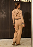 Women’s beige knit tracksuit featuring hoodie and pants with monogram detail by Shoppegasi