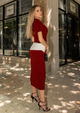 Model wearing deep red ribbed knit top and midi skirt set