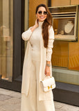 A sophisticated three-piece knitwear set in ivory, featuring high-waisted knit pants, a fitted top, and a cozy cardigan for effortless elegance and comfort.