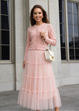 Elegant blush pink knit cardigan paired with tiered tulle maxi skirt featuring pearl buttons by shoppegasi.