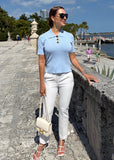 Elegant women’s blue polo shirt styled with a flattering feminine cut"