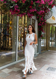 Model wearing the Franca Knit Maxi Dress in white – a sleeveless ribbed knit maxi dress featuring a fitted silhouette, side slit, and soft textured finish. Perfect for spring and Mother’s Day styling