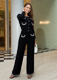 Woman in a black outfit standing in front of a fashion store