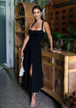 Model wearing the Isabel Bustier Sundress in Black, styled for Easter and spring with elegant accessories—perfect for a chic seasonal look.