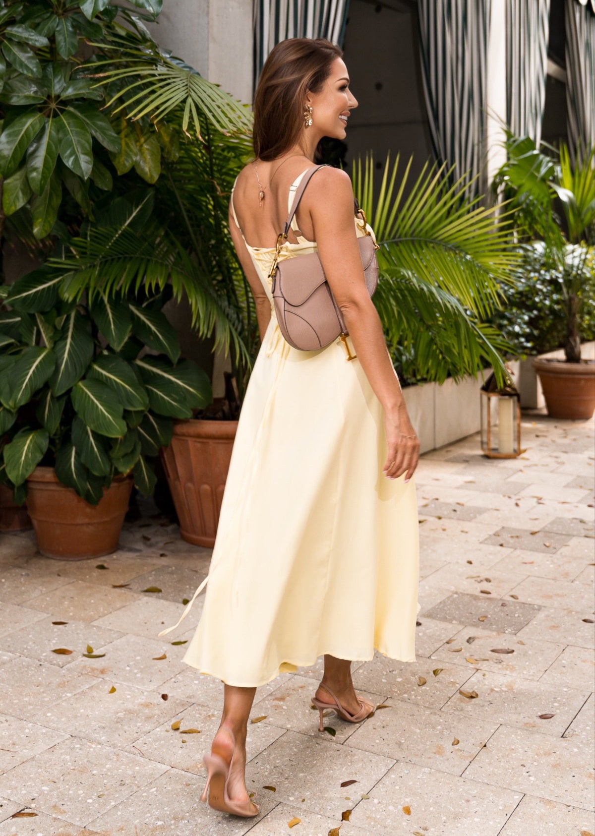 Soft yellow bustier sundress with a flared skirt and fitted top, capturing effortless boho charm for beach days and festival looks.