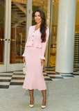 A feminine and timeless knitwear set designed for comfort and style, featuring a soft pink midi skirt and a cozy cardigan.