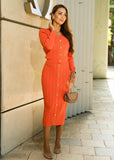 Stylish two-piece outfit in coral orange from ShopPegasi, with a body-skimming cardigan and matching high-waist skirt.