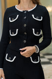 Black textured cardigan with white trim and buttons on a blurred background