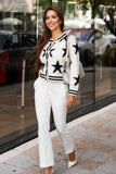 White and black star knit cardigan in size L, featuring a cozy knit fabric with a stylish star pattern and a relaxed fit.