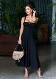Isabel black sundress styled for springtime with floral heels and soft curls.
