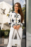 Cozy white and black star knit cardigan in size L, with a stylish design and soft knit fabric for a relaxed, chic look.