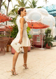 Elegant white mini dress crafted from textured knit fabric with a flattering fit.