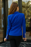 Elegant women’s royal blue blazer with gold buttons and polished business-ready style.