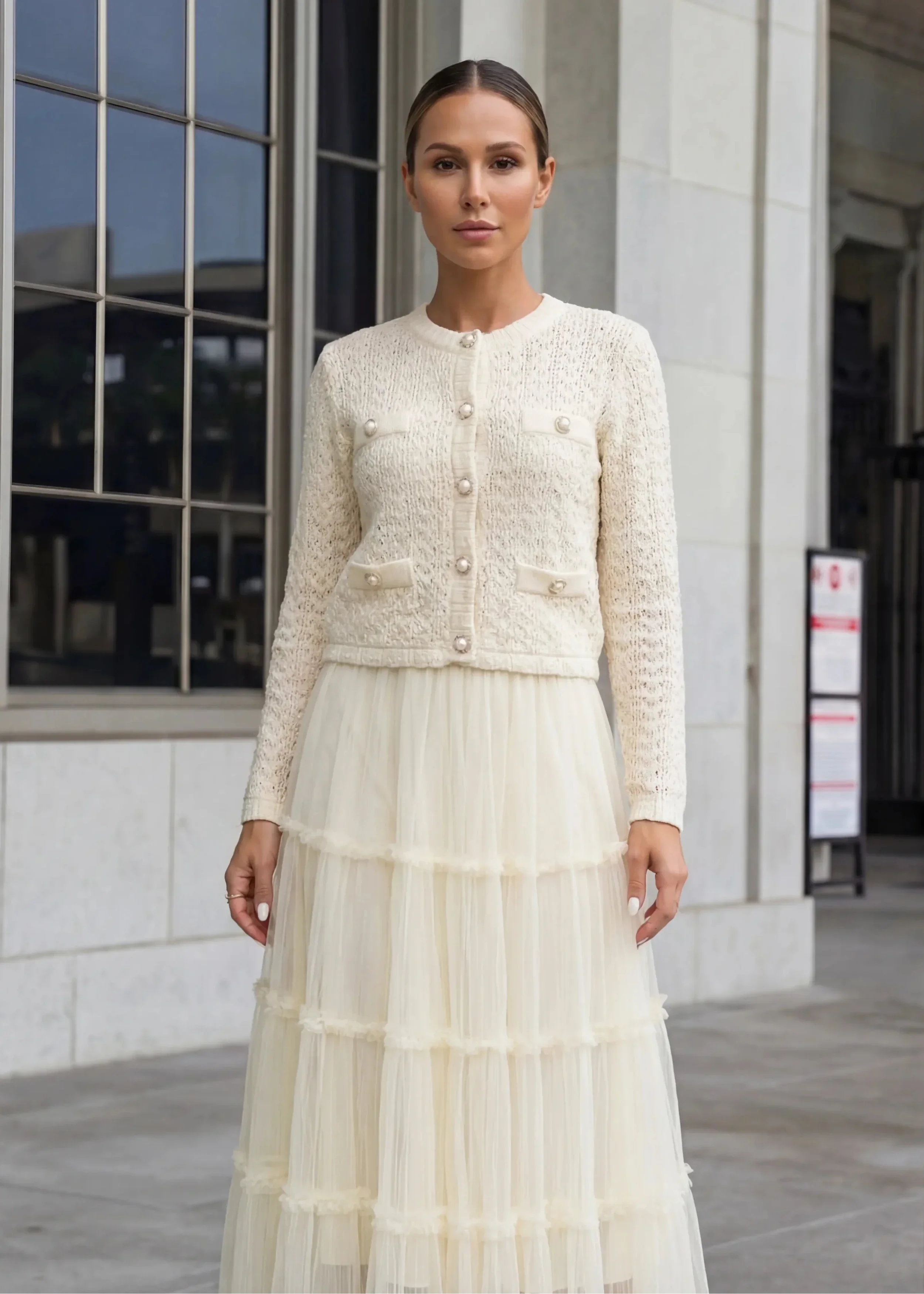 Yellow tulle crop top paired with a tiered ruffle skirt in a romantic two-piece design.