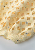 Close-up of sleeve on Bianca open-knit cropped cardigan in buttery yellow showing textured knit and airy pattern