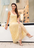 Side view of buttery yellow ribbed knit midi dress showing fitted waist and flowy hem