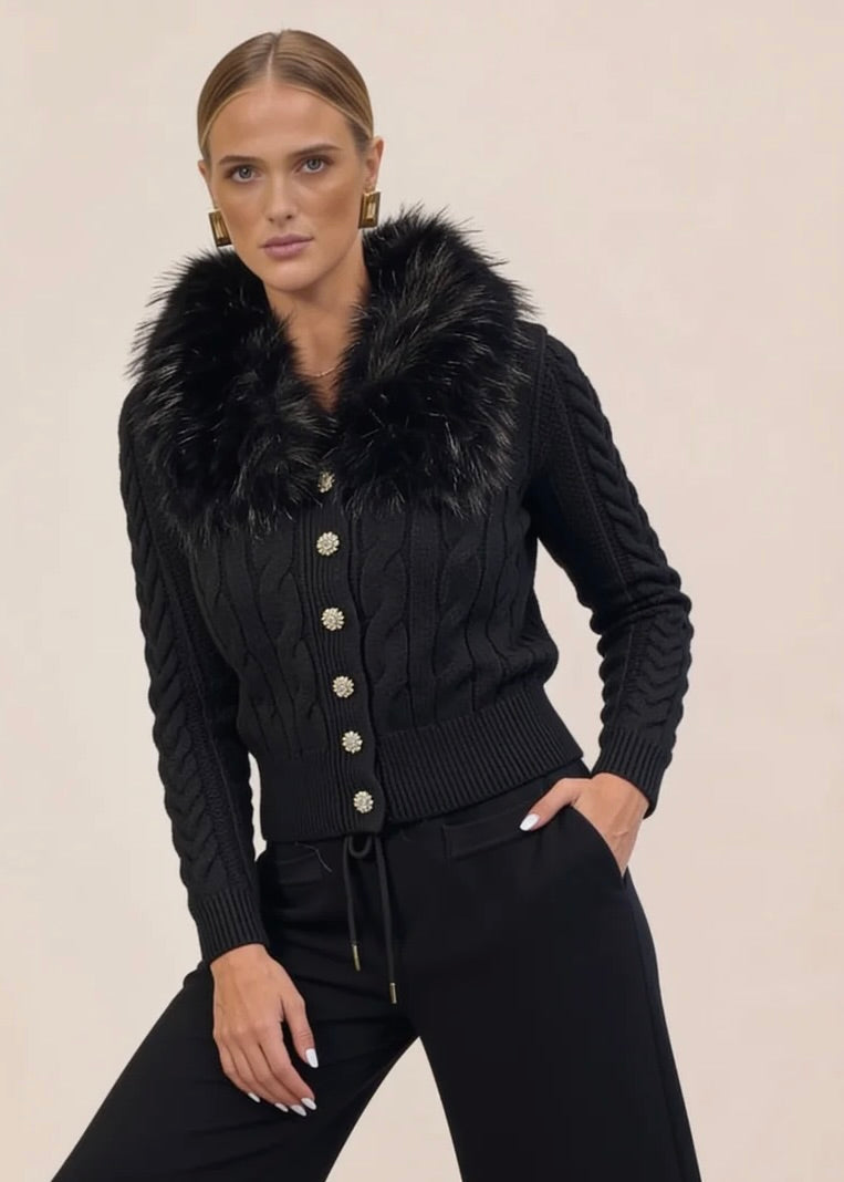 Woman in black knit cardigan and wide-leg pants set with hand in pocket, dynamic pose