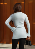 Back view of blue ribbed knit longline cardigan showing length and silhouette.