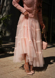 Back view of blush tiered tulle set showing full layered skirt silhouette
