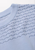 Close-up detail of powder blue pointelle knit maxi dress texture and craftsmanship