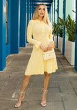 Buttery yellow dress styled with handbag for brunch or event outfit