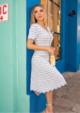 Elegant powder blue knit dress styled for spring brunches, garden parties, and daytime events