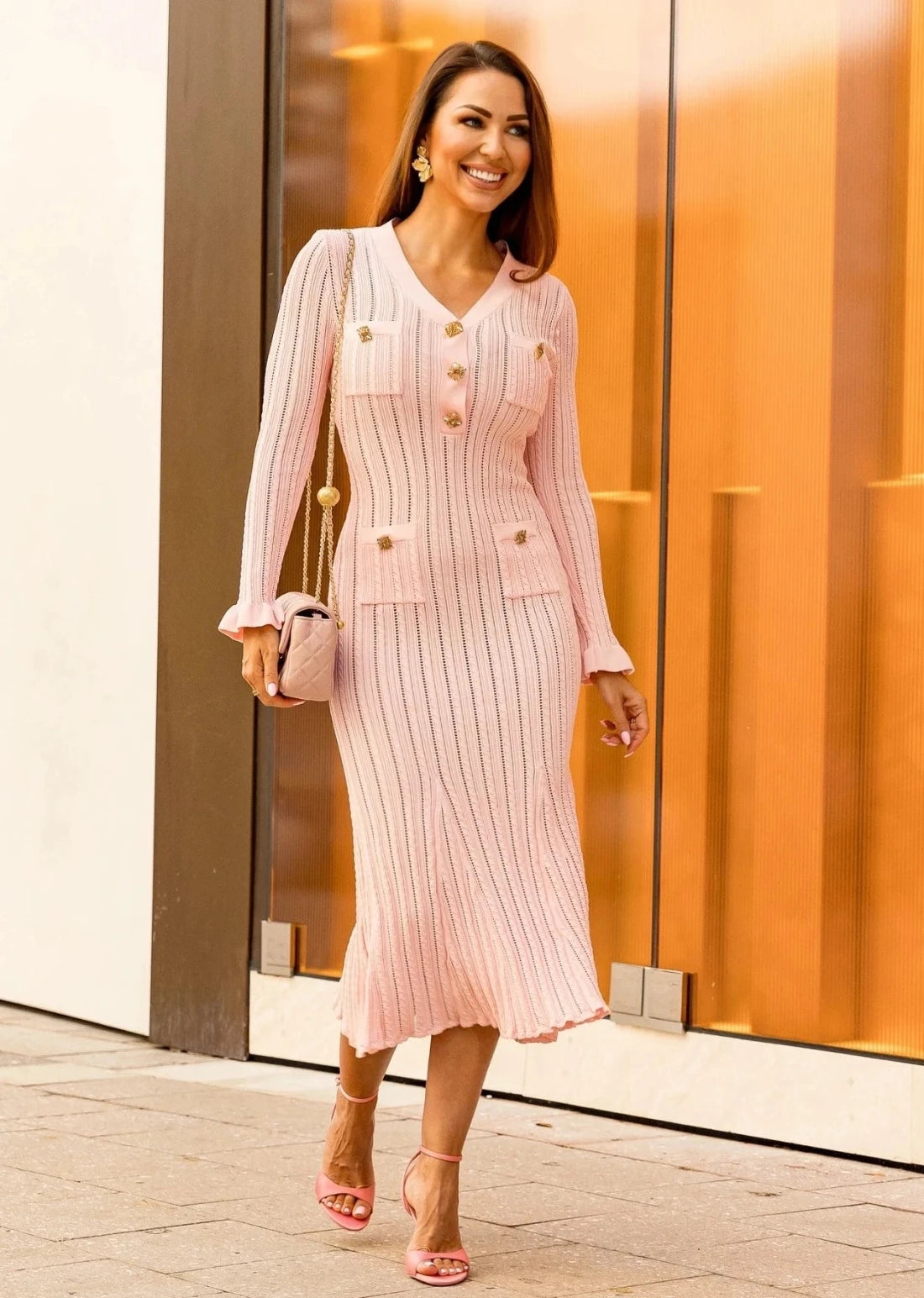 Close up of ribbed knit dress with gold button detailing