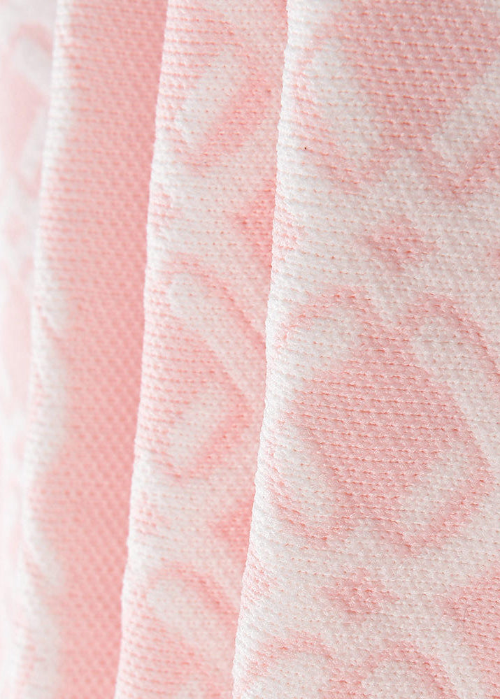 close up of blush pink knit dress fabric showing soft texture and detail