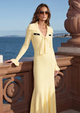Close-up of Marisol sailor collar and tie-neck bow with pearl buttons