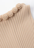 close-up of textured ribbed knit fabric and neckline detail on mini flare dress