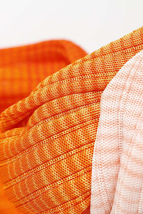 Orange and pink ombre midi dress styled for elegant summer outfit, fitted ribbed knit design