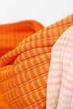Orange and pink ombre midi dress styled for elegant summer outfit, fitted ribbed knit design
