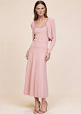 Pink ribbed knit cardigan worn open over matching pearl and crystal trim midi dress