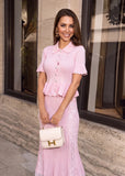 Pink knit cardigan paired with a lace panel skirt in a coordinated women's knitwear set