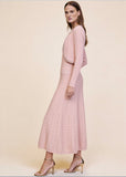Side view of pink ribbed knit cardigan and pleated midi dress set with pearl and crystal trim, full body