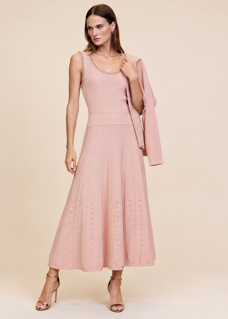 Pink ribbed knit cardigan worn open over matching pearl and crystal trim midi dress, full body