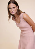 Close-up of pink ribbed knit midi dress with pearl and crystal trim at the neckline, dress alone