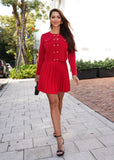 Red embellished knit cardigan and skirt set styled as an elegant coordinated outfit