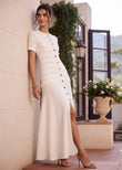Serafina ivory cream white textured knit maxi dress with gold button front, drop waist, hip pockets, and front slit
