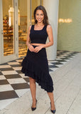 Women's black crop top and skirt set styled for an evening look