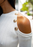 Chic white midi-length dress styled with minimalist accessories, featuring unique shoulder cut

