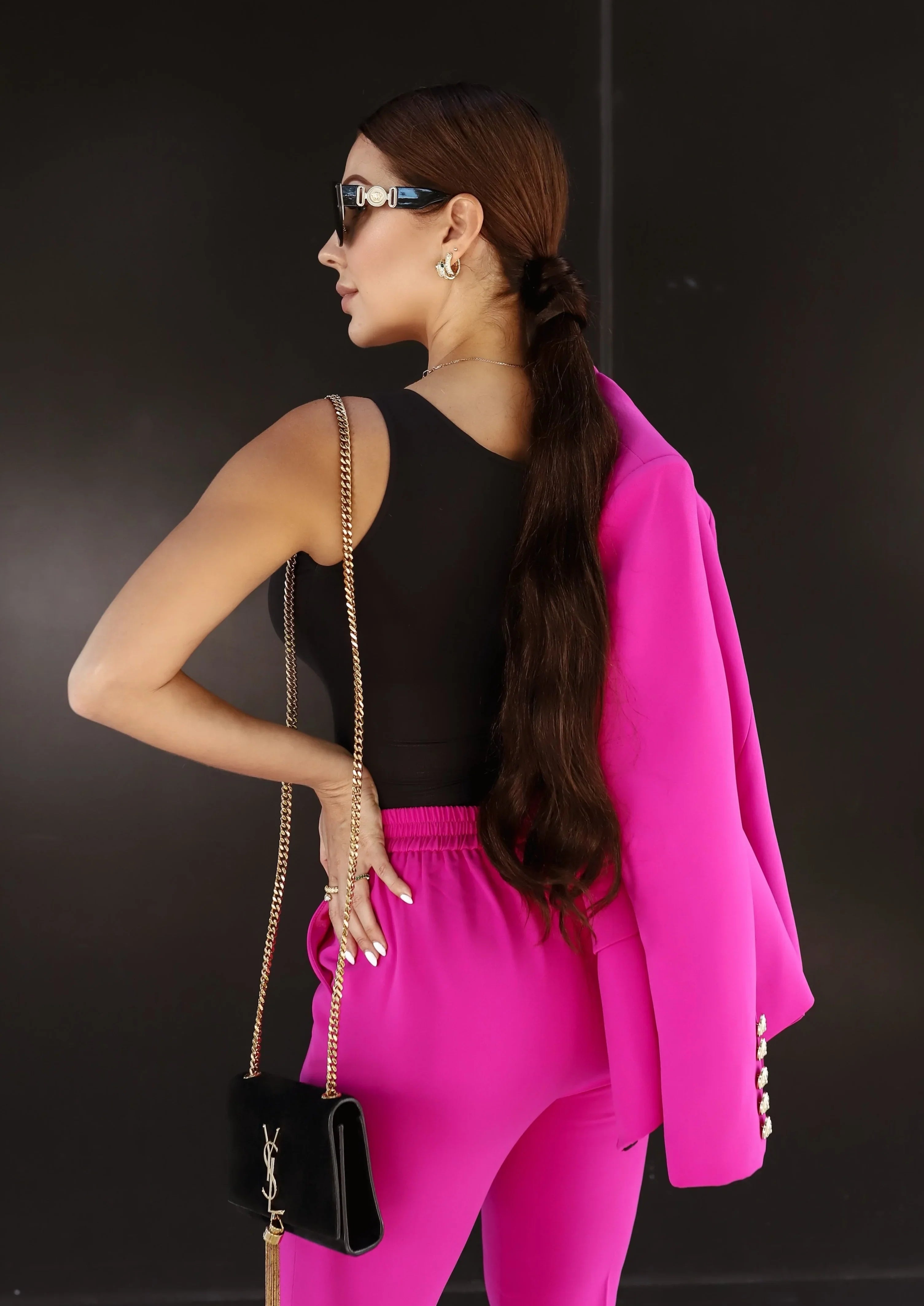 Tailored fuchsia blazer and pants suit with a fitted waist and gold buttons
