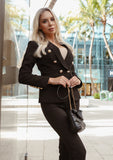 Minimalist yet bold – black double-breasted blazer and pants for a sleek look.