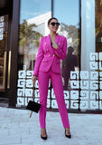 Luxury women’s double-breasted blazer and fitted pants set in vibrant pink