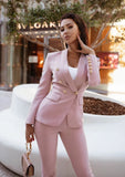 Women’s pink blazer and pants set featuring double breasted buttons